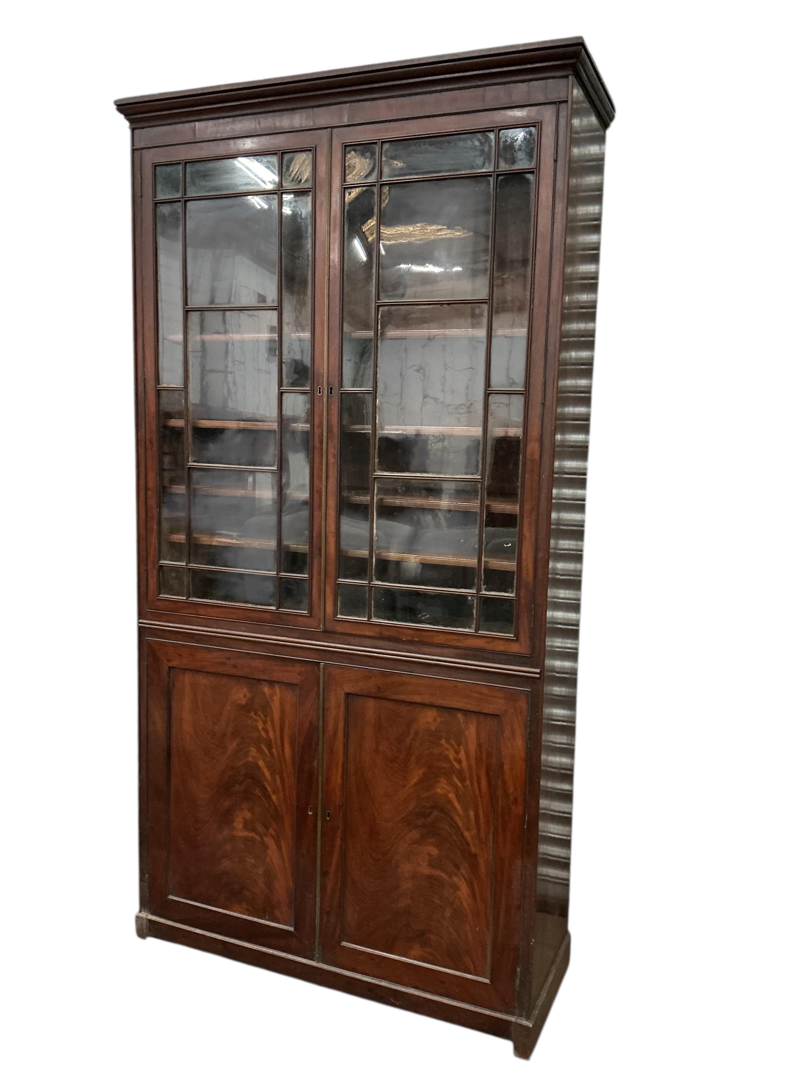 A George III mahogany bookcase, width 112cm, depth 42cm, height 225cm